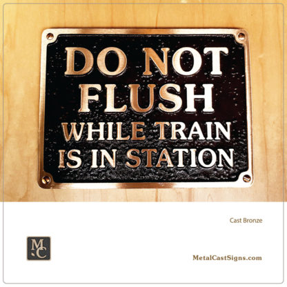 DO NOT FLUSH WHILE TRAIN IS IN STATION - cast bronze sign