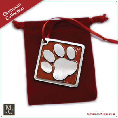 Ornament - dog print - sand cast aluminum - red powder coat background - red velvet bag