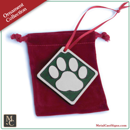 Ornament - dog print - sand cast aluminum - green powder coat background - red velvet bag