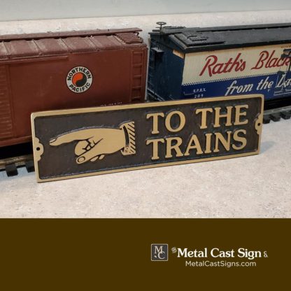 TO THE TRAINS pointing left bronze sign vintage look