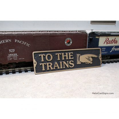 To THe Trains - hand pointing sign - cast bronze